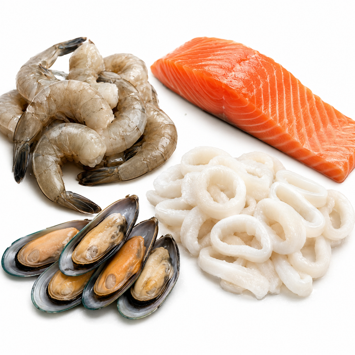 Assorted raw seafood including shrimp, salmon, mussels, and squid on a white background