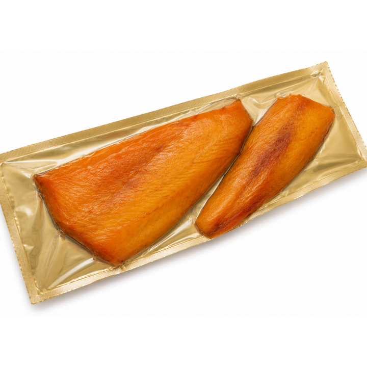 Two pieces of smoked haddock in a gold packaging on a white background