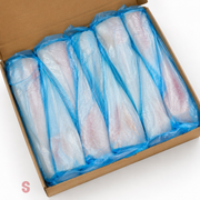 Box containing multiple packages of raw hake fish fillets in blue plastic wrap on a white background.