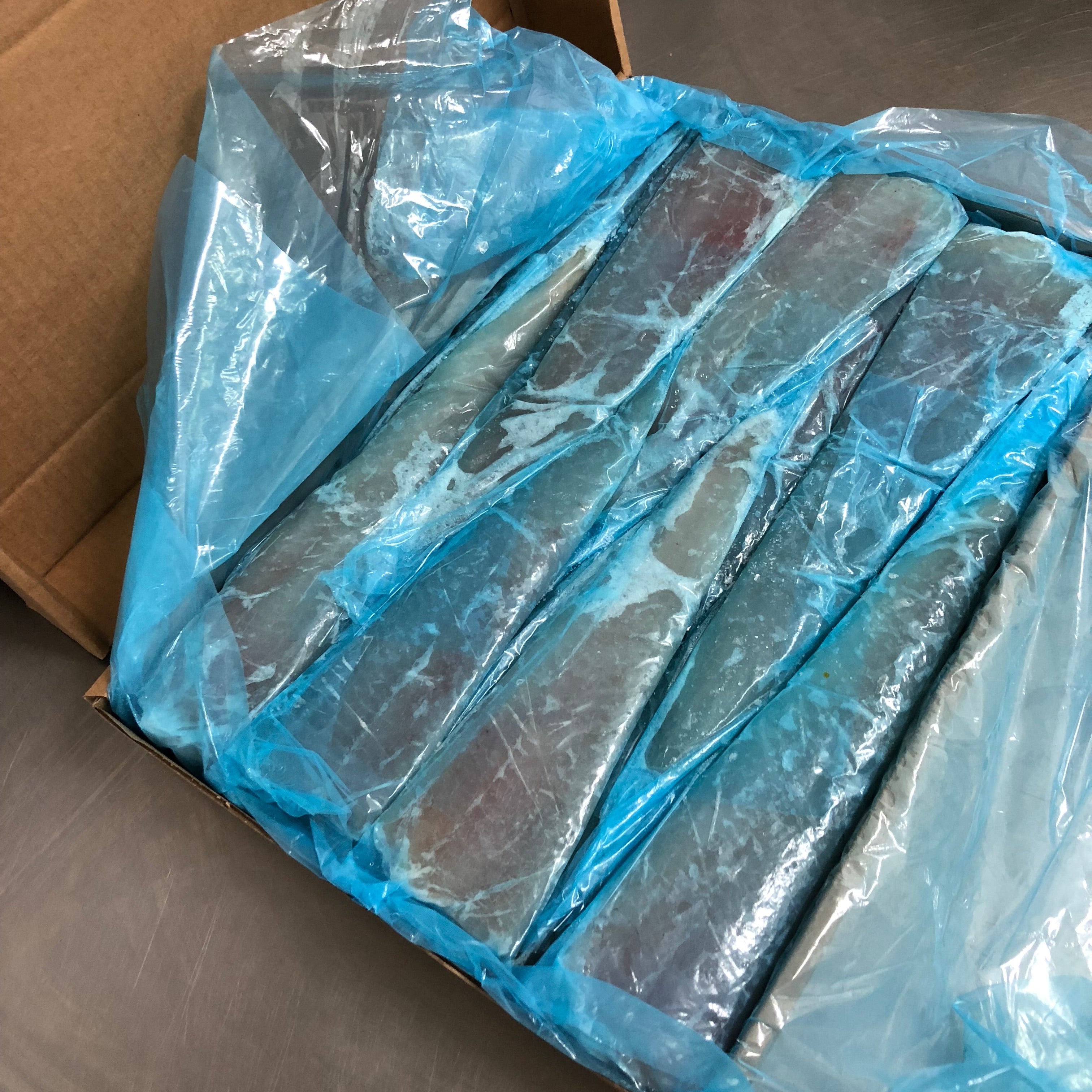 Packaged hake fillets in blue plastic in a cardboard box