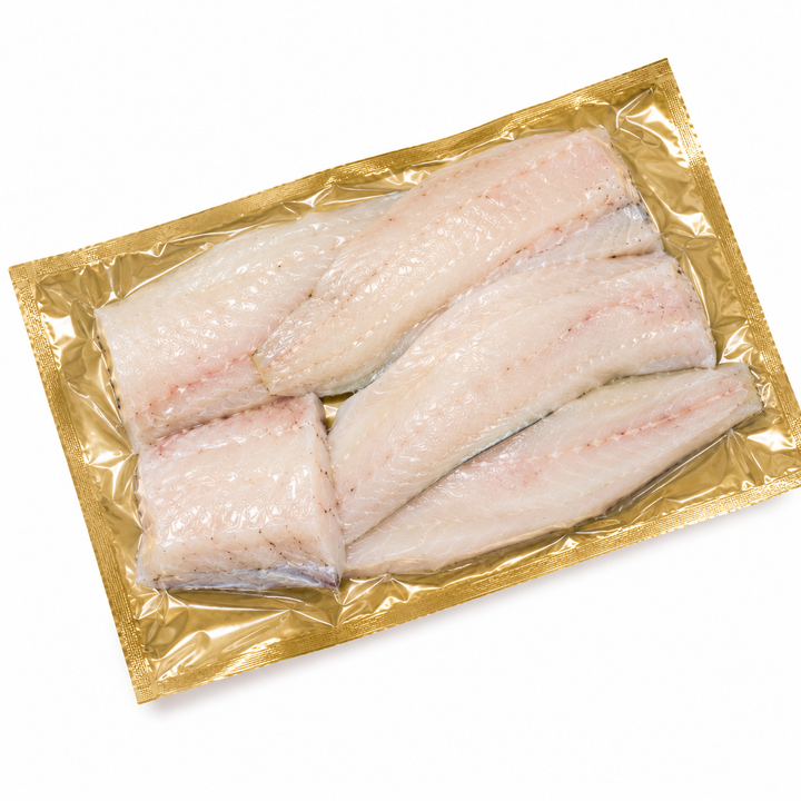 Packaged raw hake fish fillets in a gold vacuum sealed package with a white background