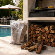Stack of firewood next to a barbecue grill by a poolside