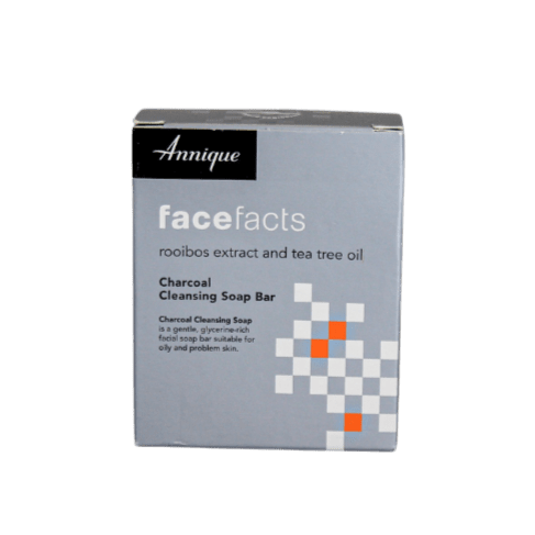Box of Annique facefacts charcoal cleansing soap bar on a green background
