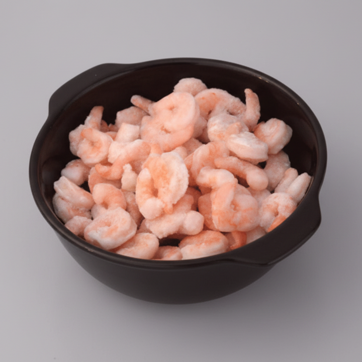Prawns in a black bowl on a mosaic tile surface